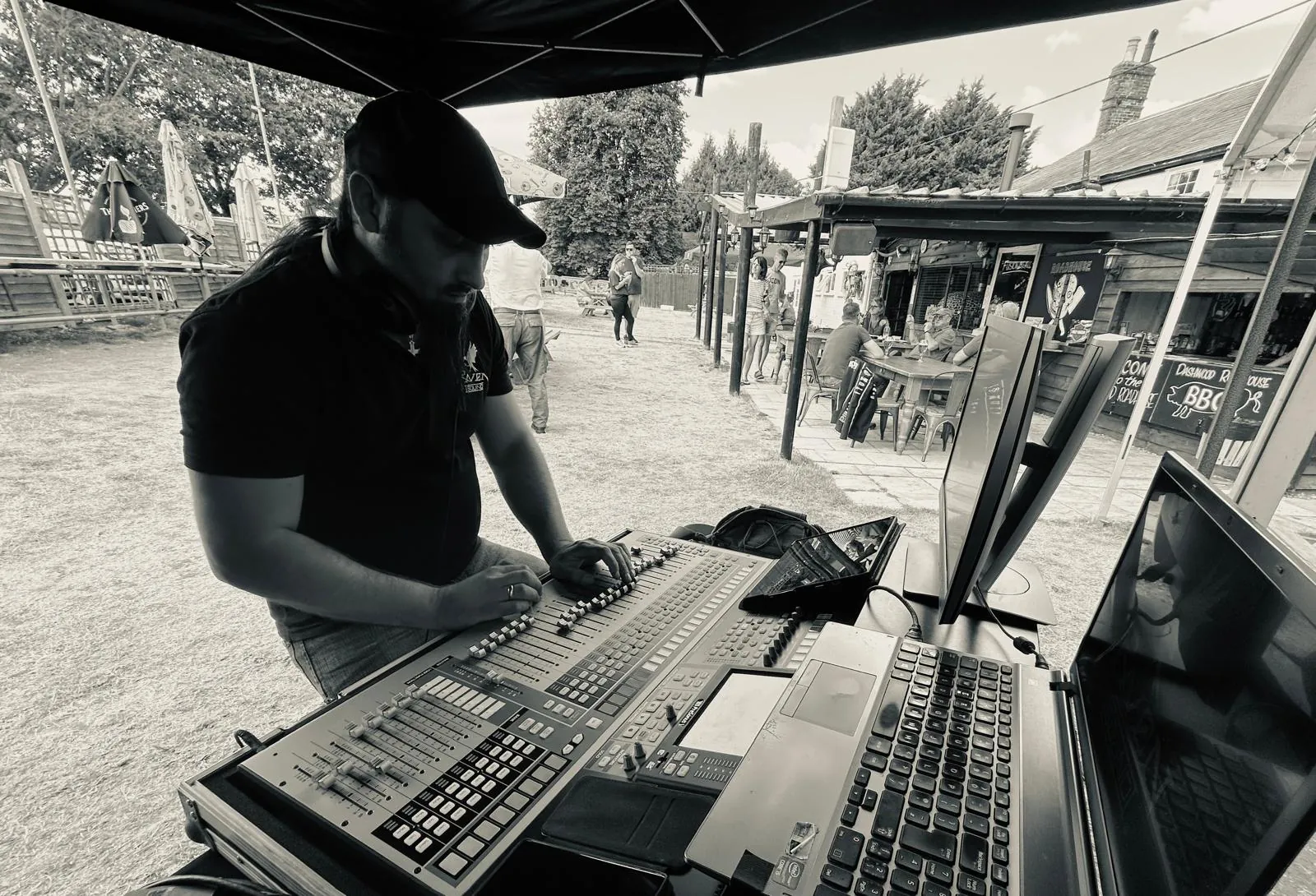 Jamie working the desk at an outdoor gig