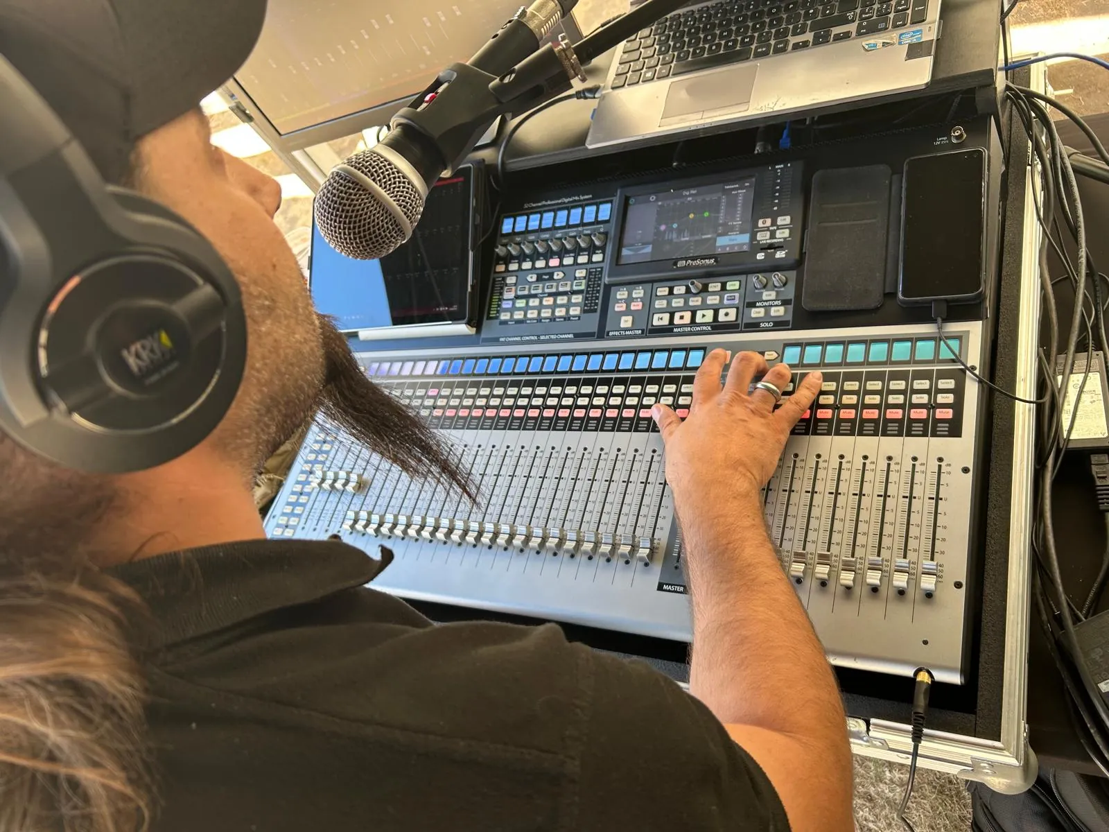 Jamie at the mixing desk wearing headphones